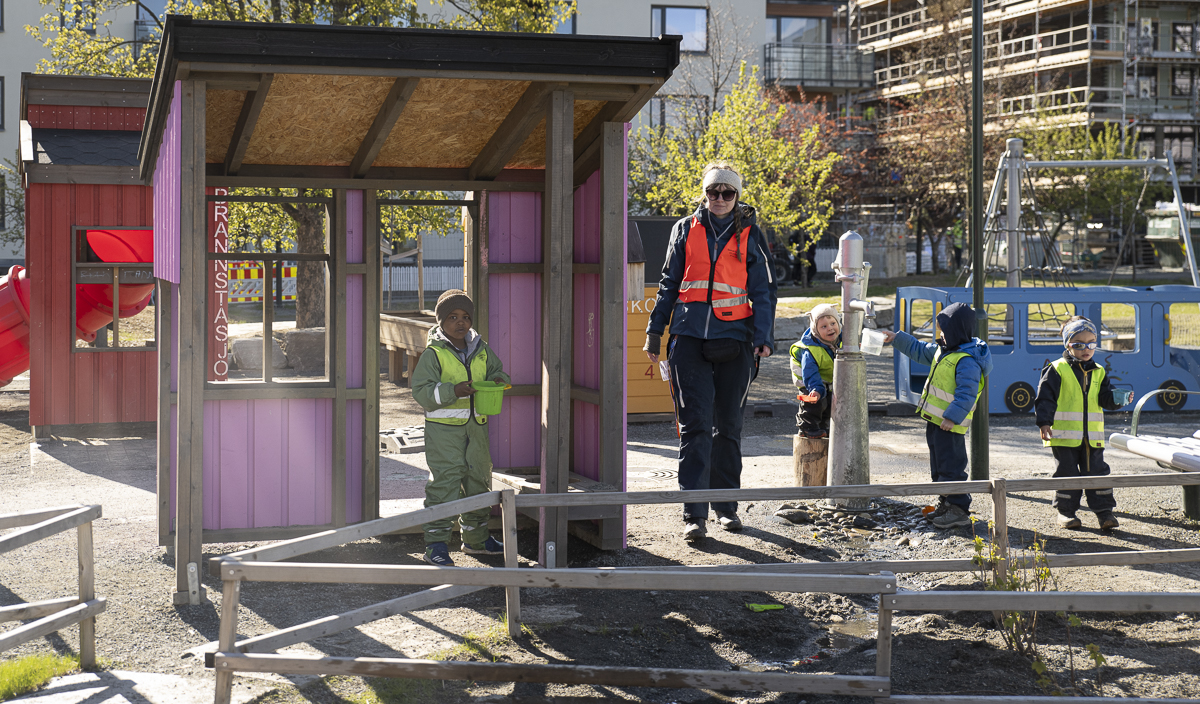 Barn og ansatt på lekeplass