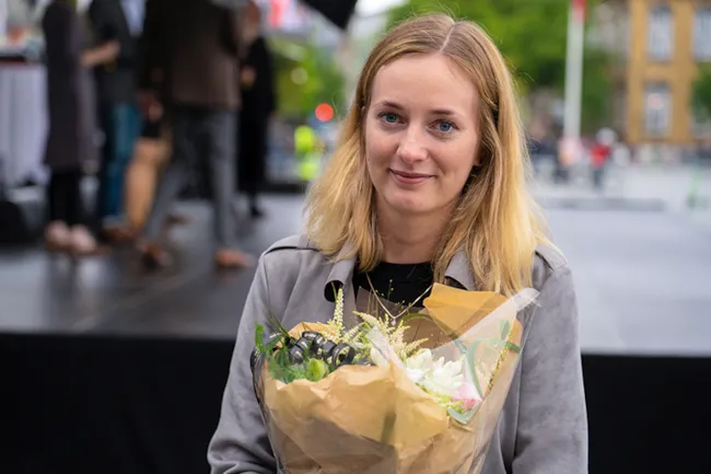 Portrett av Oda Okkenhaug med blomsterbukett